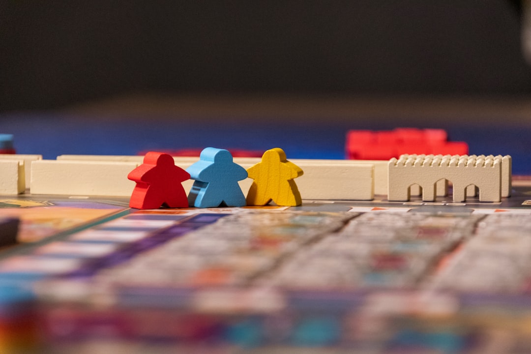services-09 Red, blue, and yellow meeple figures in the game Merv.